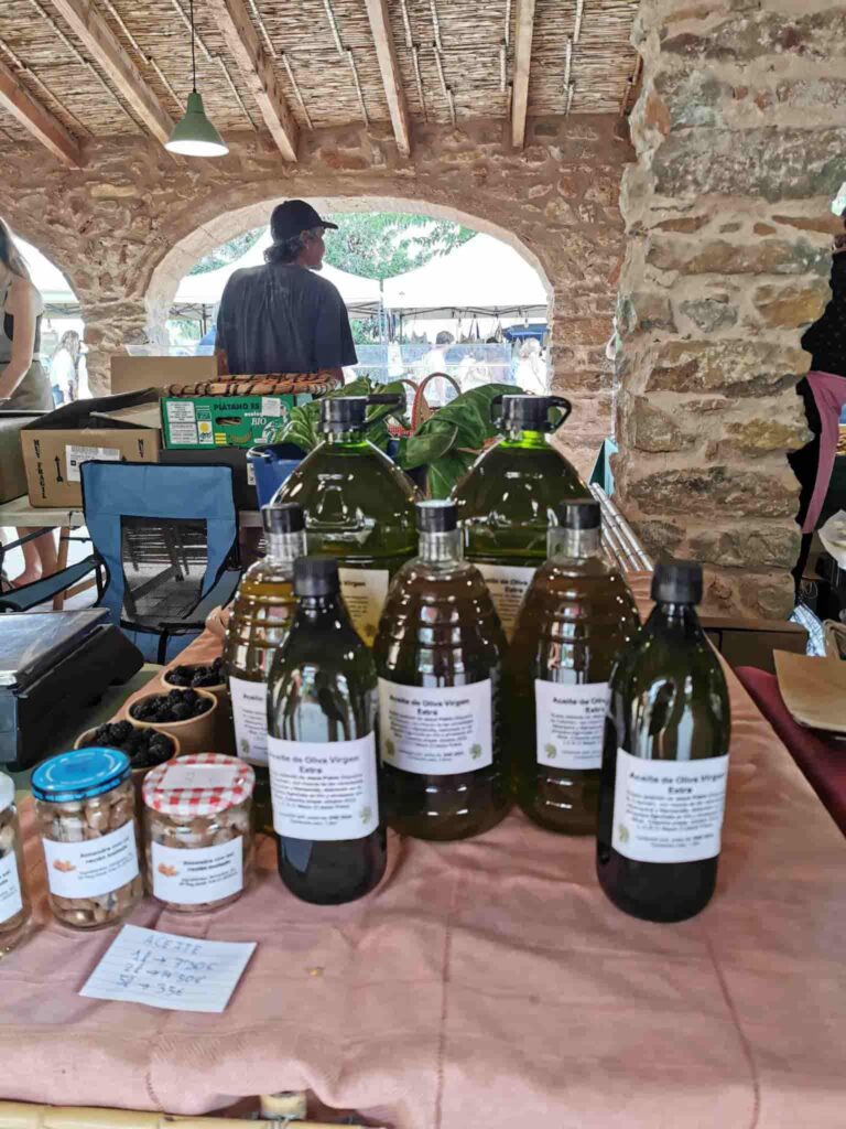 Bottles of locally made Olive oil stall in the Market Del Riurau in Jesus Pobre.