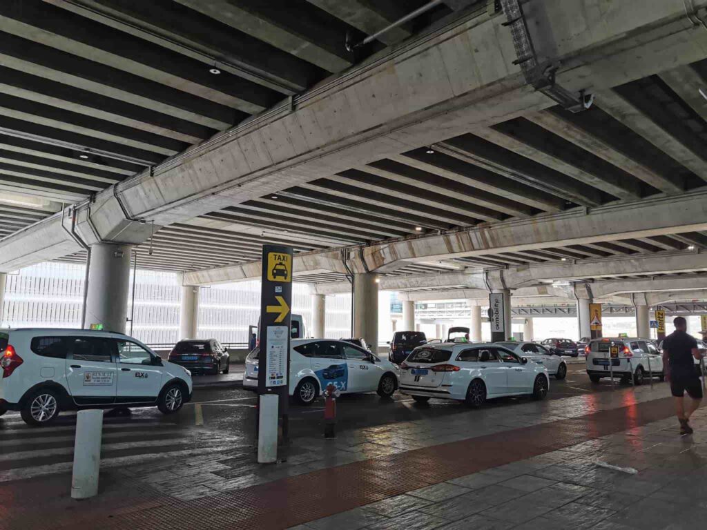 Taxis sat at the taxi rank, located at Level 0 of the airport.